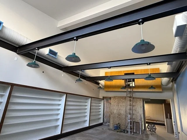  Another angle in the train room, looking up at the pendant lights along the steel beams with the built-in shelving below. 