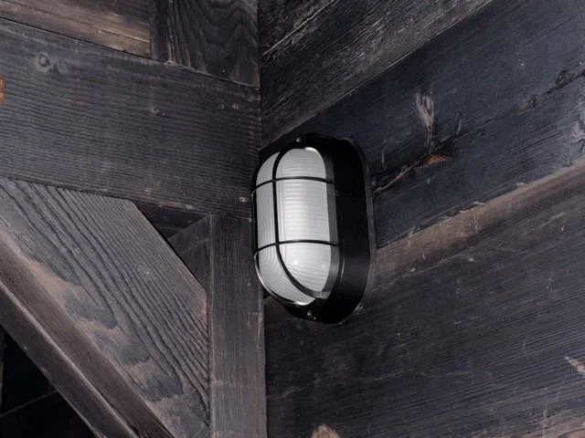  Close-up of the oval caged wall light in the tunnel. 