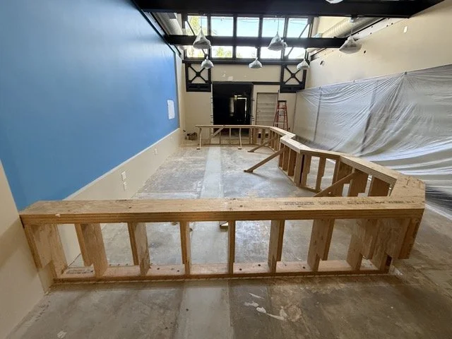  Looking toward the tunnel entrance: the framing runs along the floor under the skylight windows, with the plastic-covered wall on the right. 