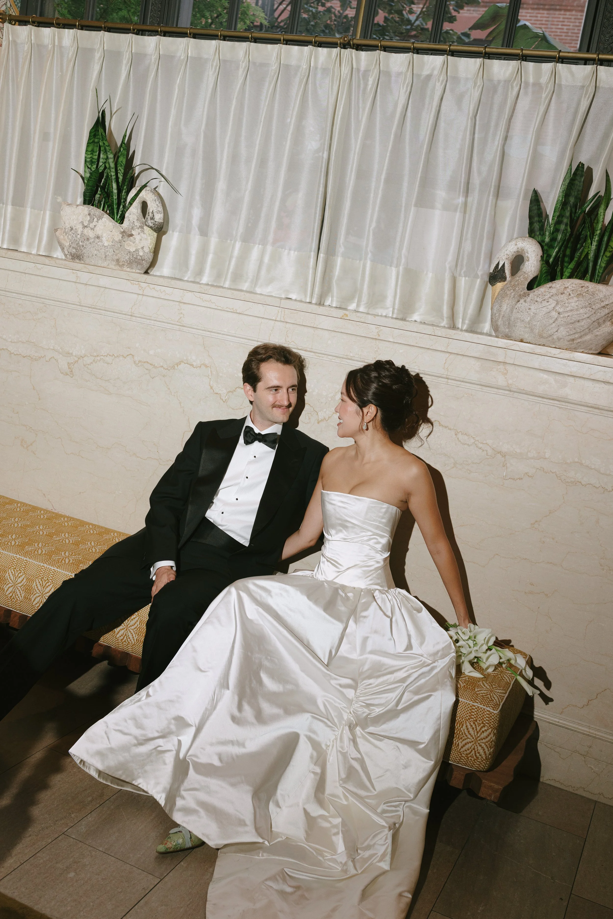 Bride and Groom posing for photos at Nine Orchard in NYC on film