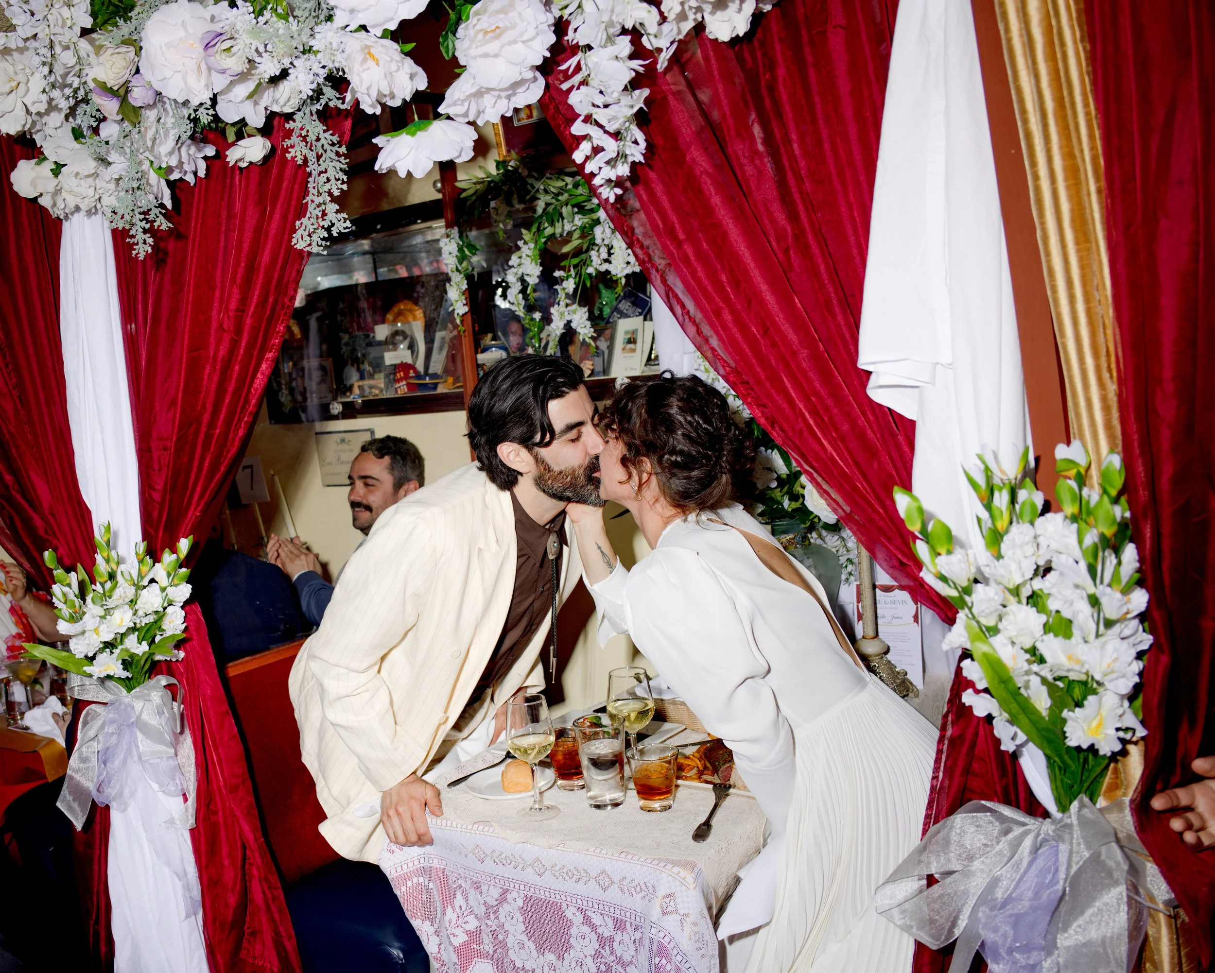 Kansas City Wedding at Le Frou Frog, couple kissing during dinner at a classic french restaurant for special occasions