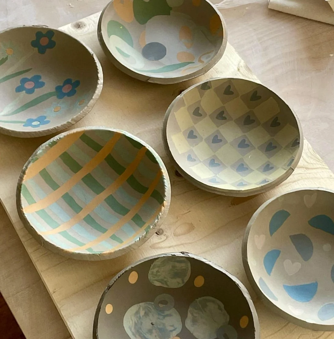 Lady building a coil pot using her hands