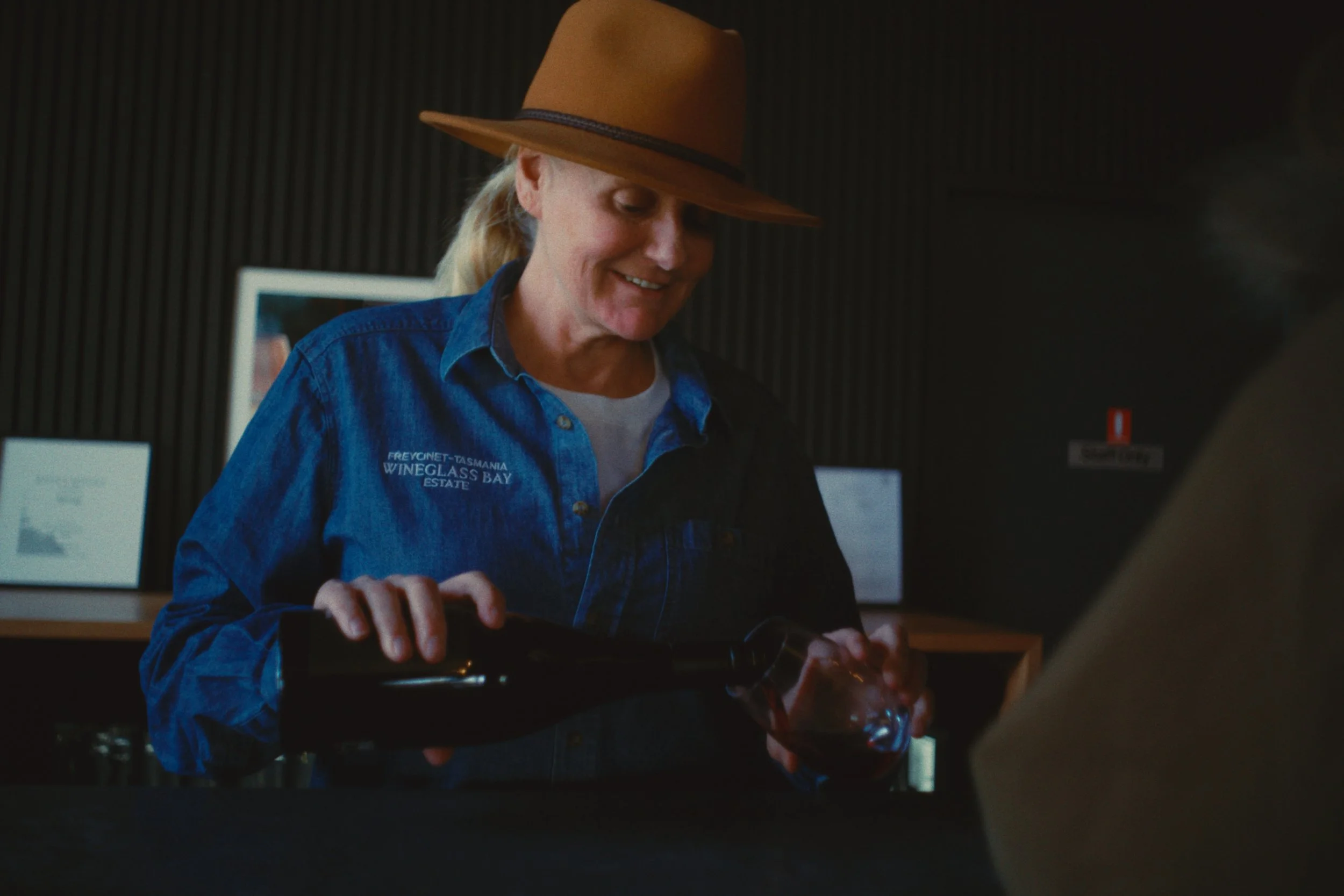 Kim pouring Kitty's Mistake wine at the Wineglass Bay Estate cellar door