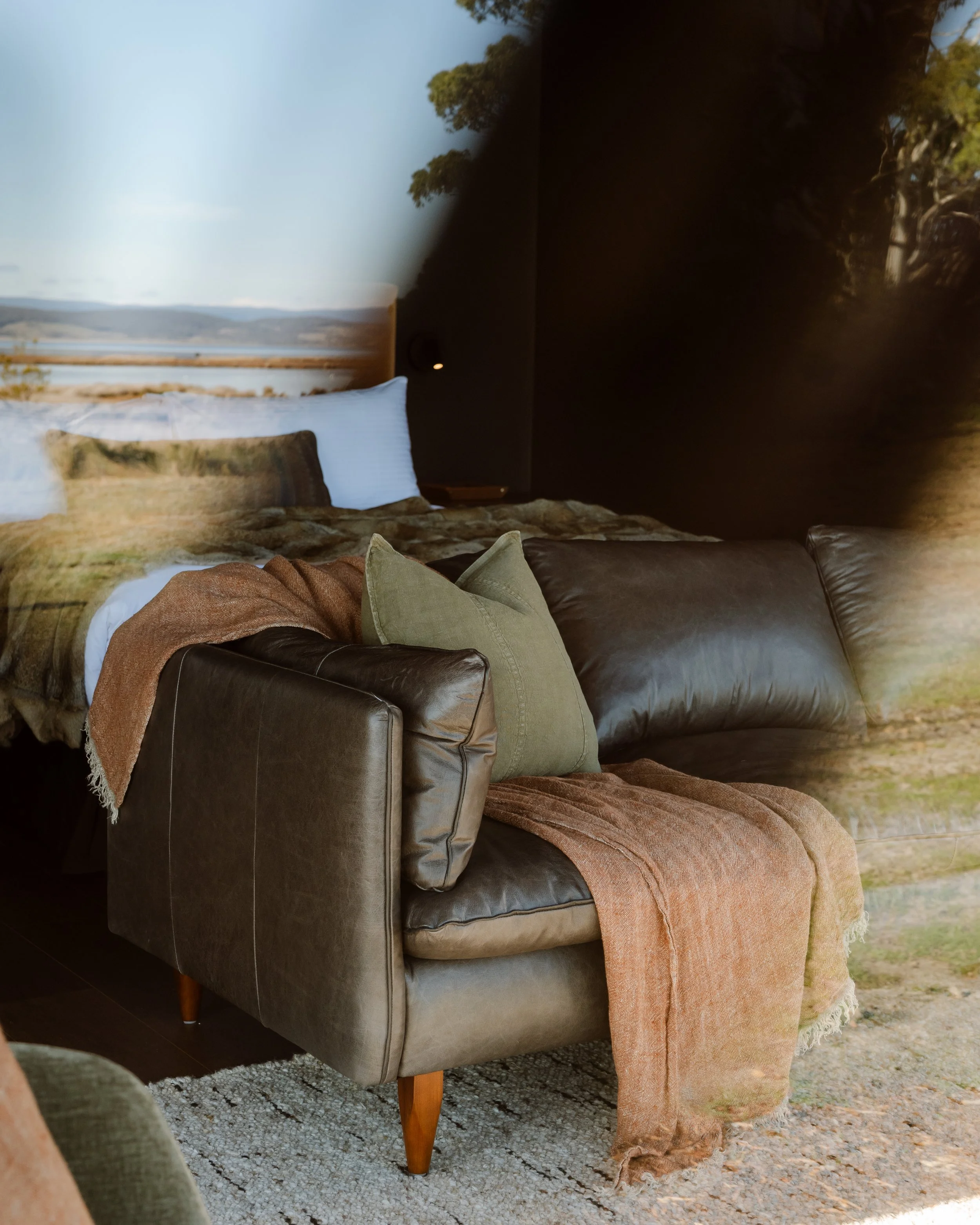 Cosy retreat sofa reflecting the bush view – accommodation near Freycinet