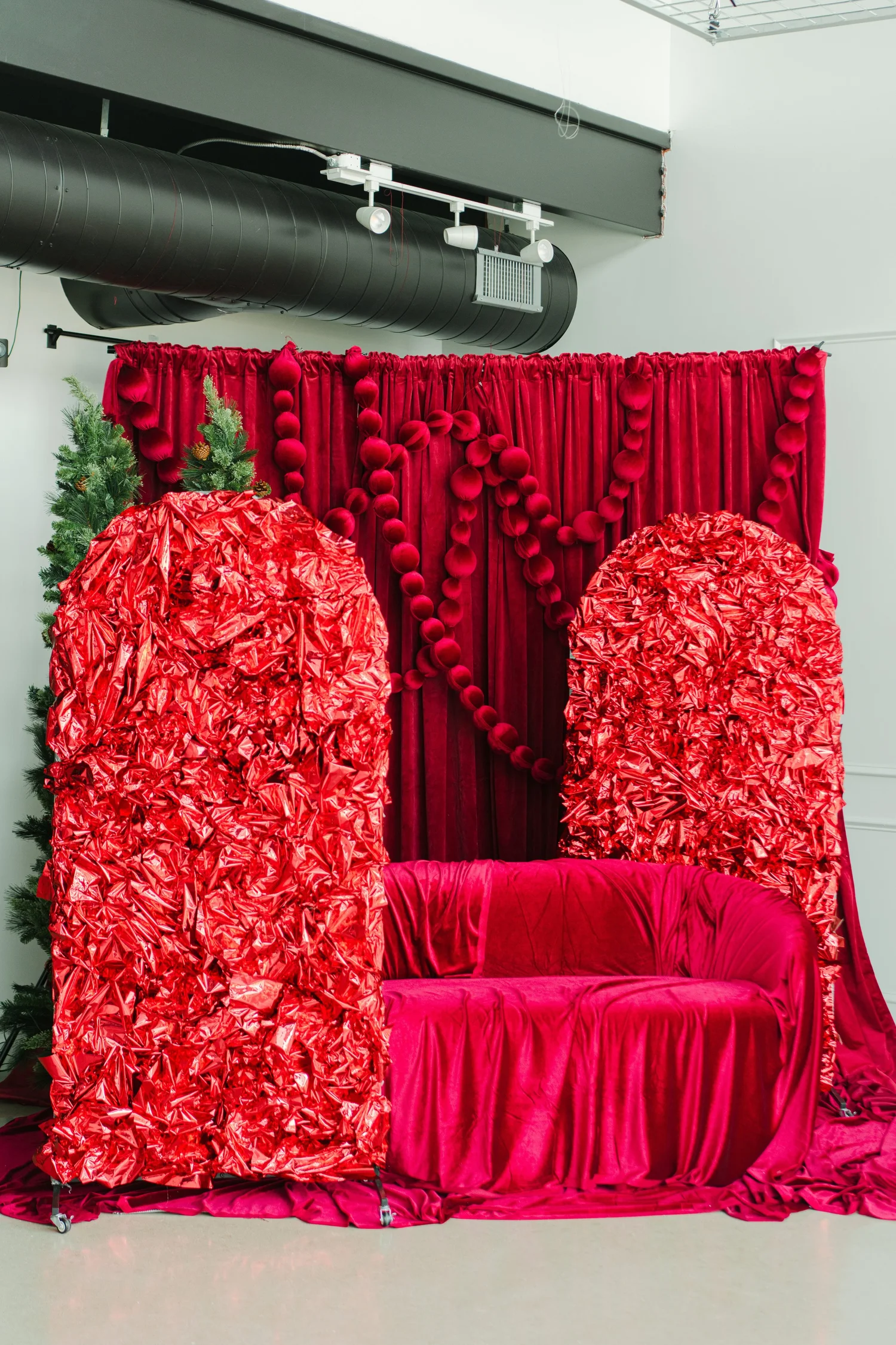 Red foil arches in front of the cranberry velvet drape on the Red Velvet holiday set