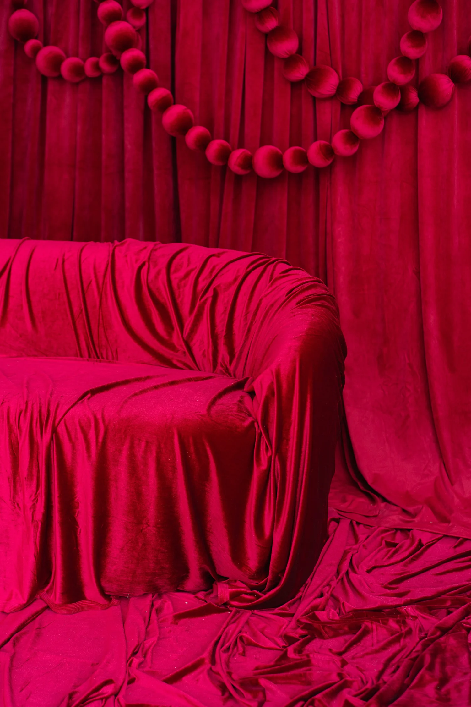 Ruched cranberry velvet loveseat and drape on the Red Velvet Christmas photo set