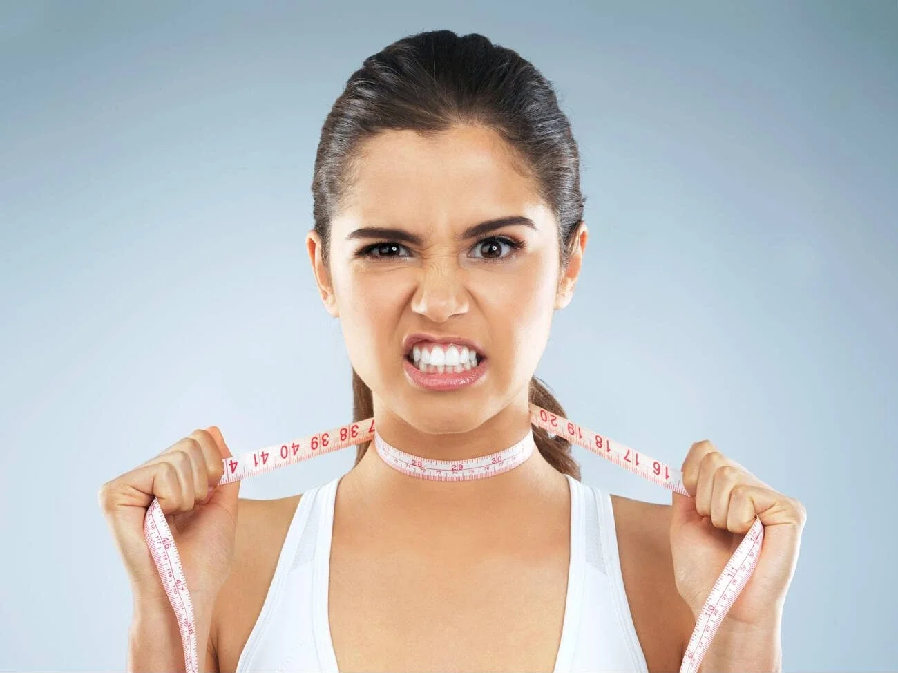 Angry, woman and portrait with measure tape and choke from difficult diet, weight loss issue and body standards. Frustrated, problem and upset from