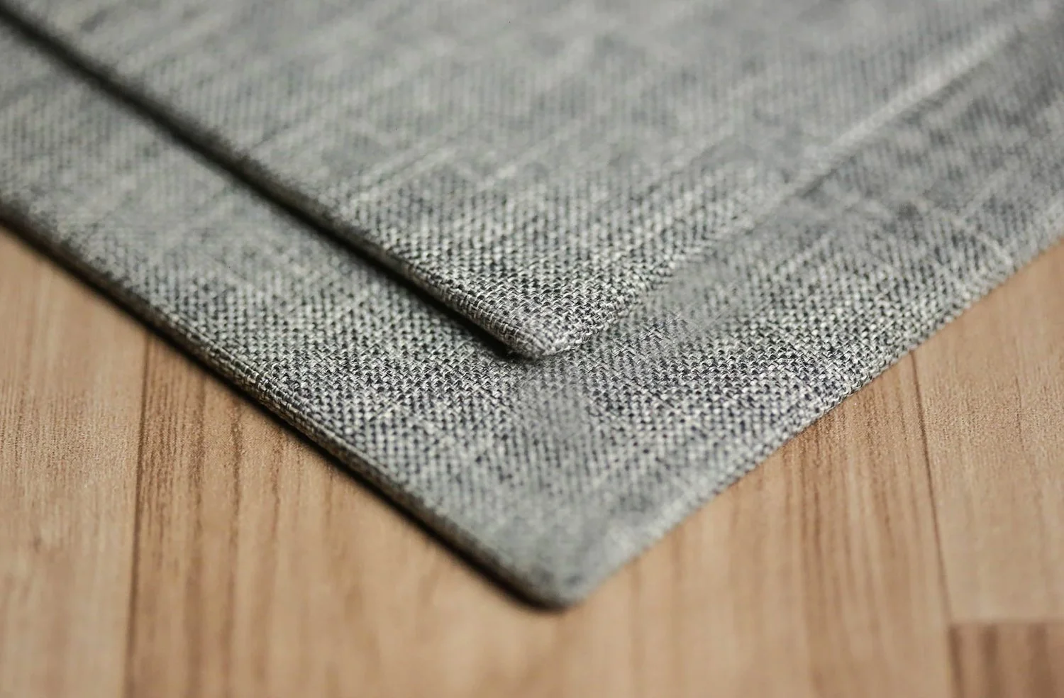 Close-up of grey textured fabric on wooden surface