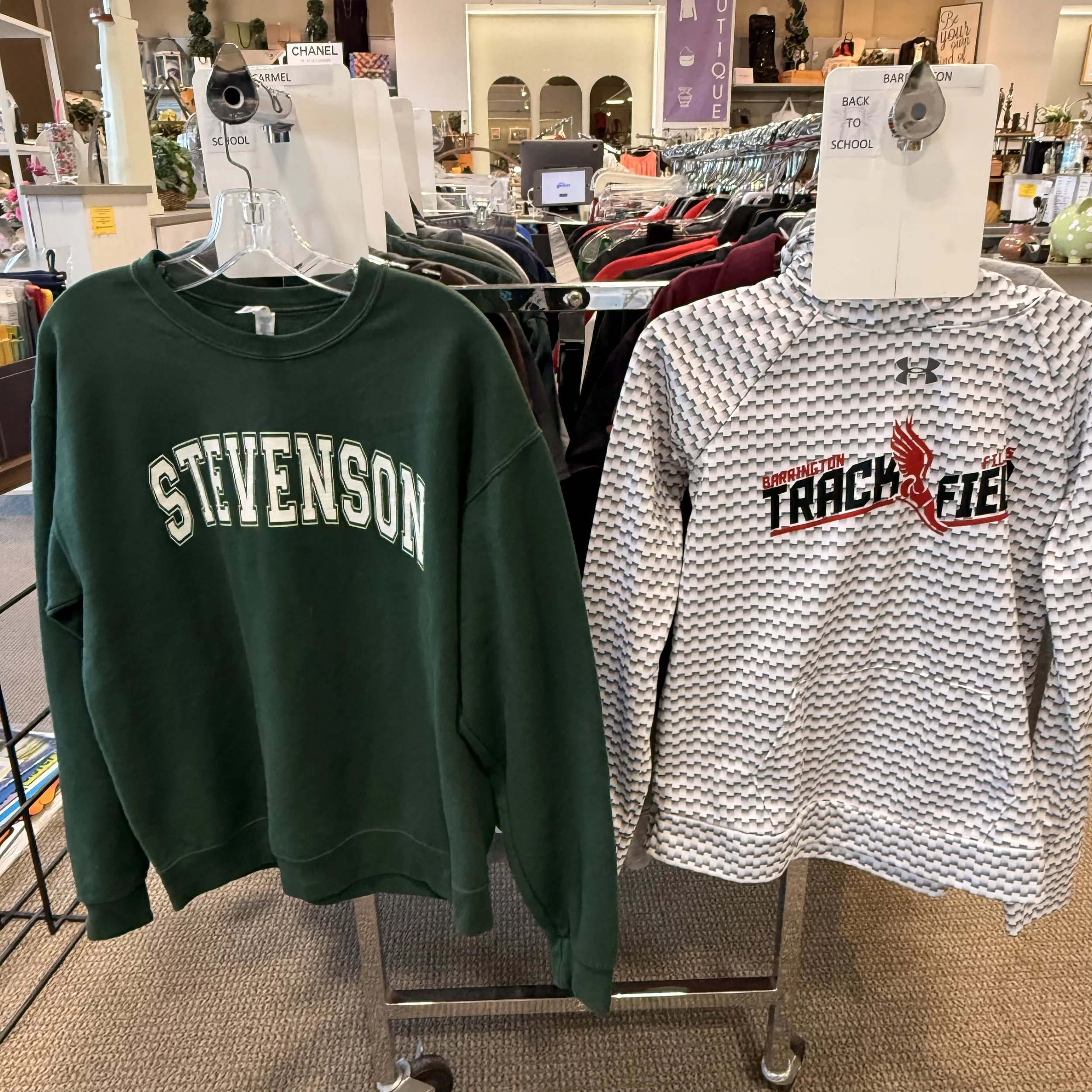 Gently-used college and school spirit apparel at House of Hope Resale in Lake Zurich featuring Stevenson and Barrington clothing, offering affordable back-to-school and college gear for students and alumni.