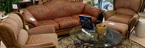 Upholstered sofa, armchairs and glass coffee table in the furniture showroom at House of Hope Resale thrift store in Lake Zurich, IL.