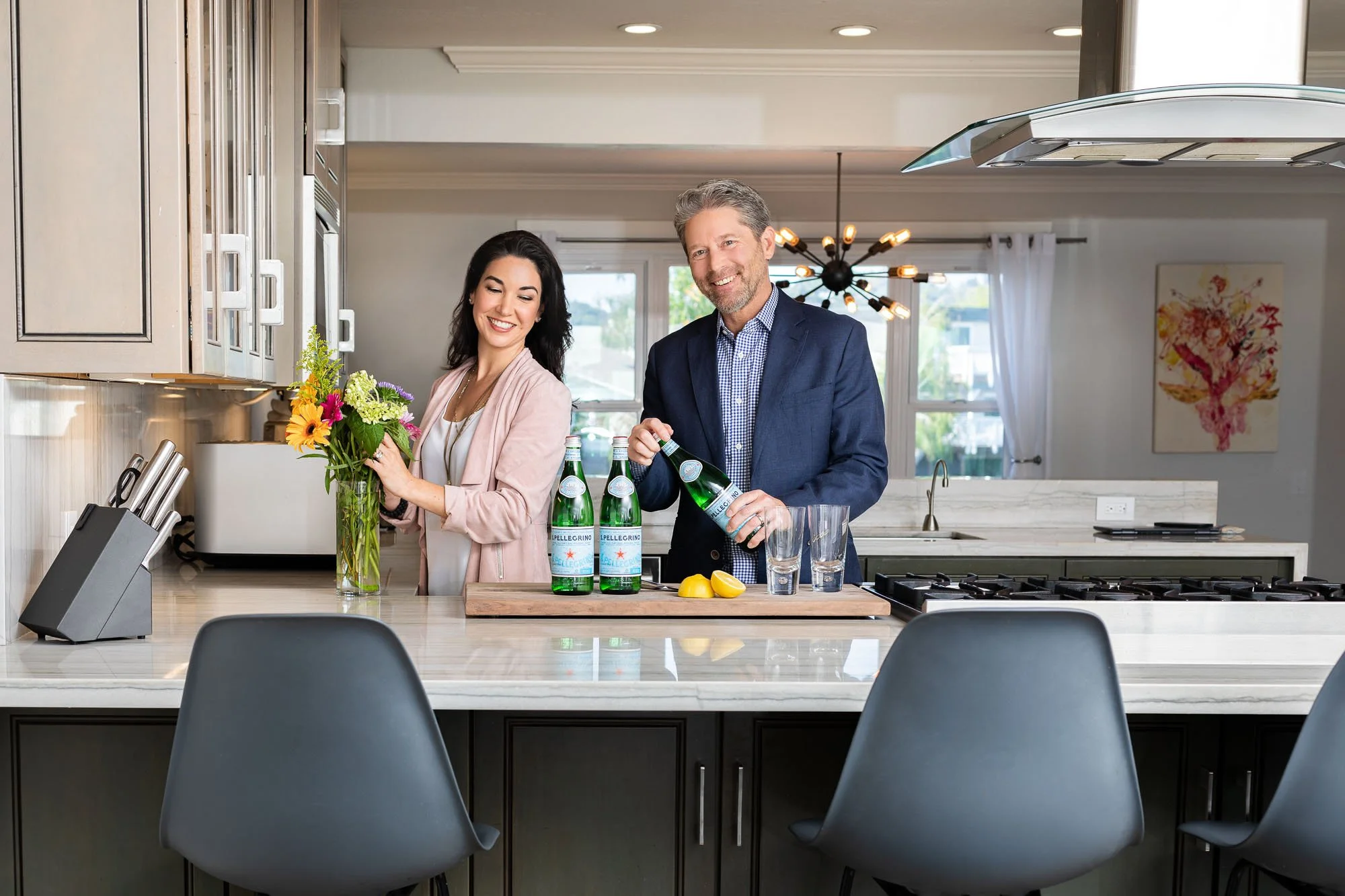 Commercial lifestyle photo of real estate agent team man and woman preparing luxury kitchen for home showing in Tiburon CA, San Francisco Bay Area commercial lifestyle photographer