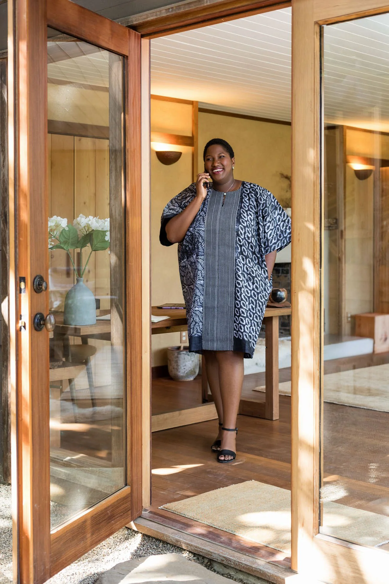 Personal branding portrait of Black woman on phone in stylish warm office, San Francisco Bay Area commercial photographer