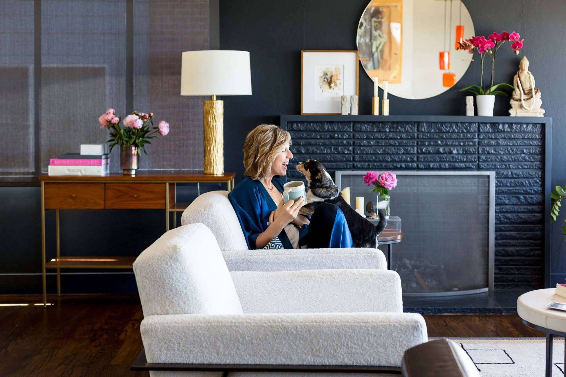
Commercial lifestyle personal branding photo of small business interior designer relaxing on white couch with dog and coffee mug in beautifully styled home, San Francisco Bay Area lifestyle photographer