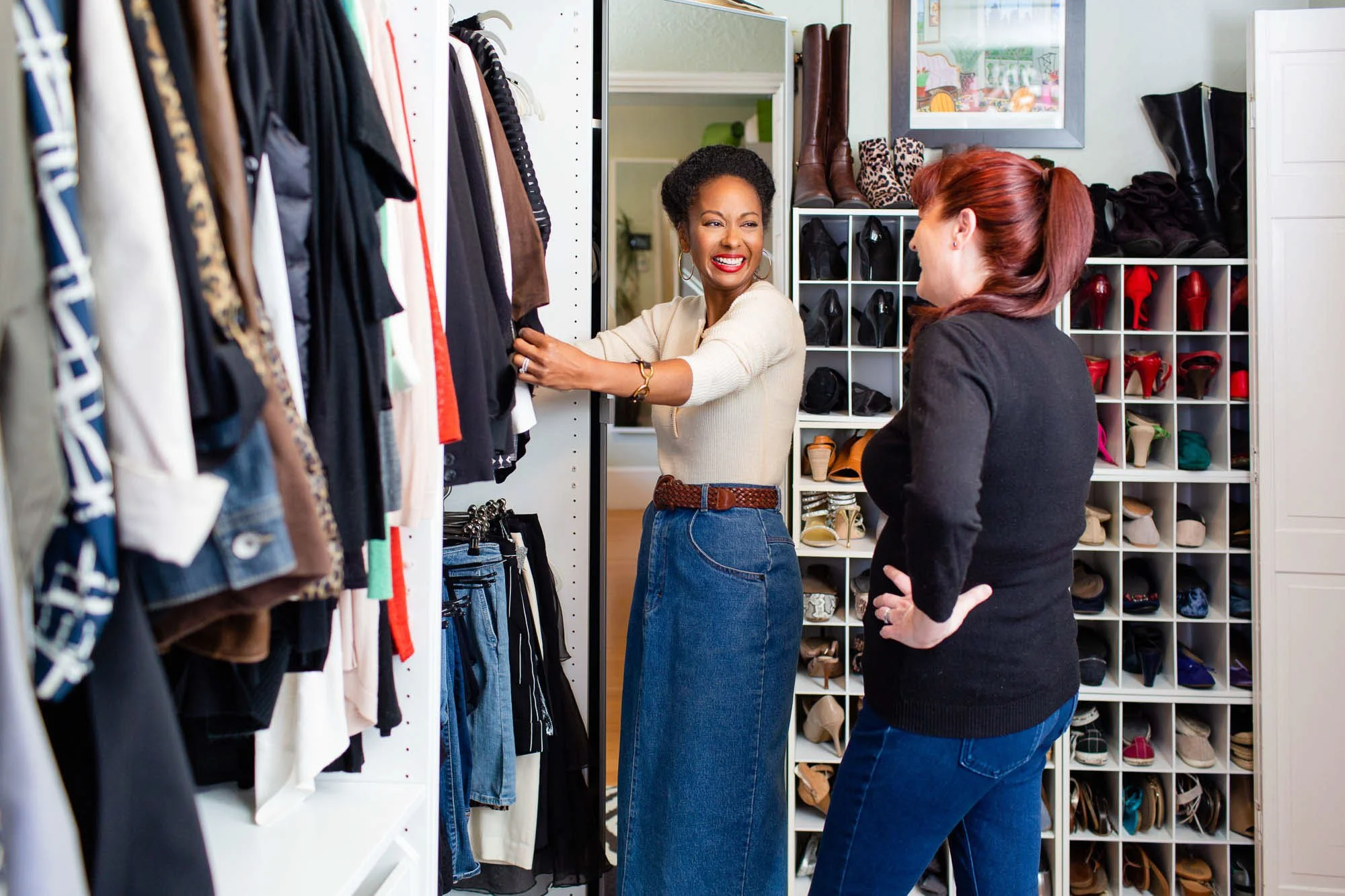 Black female stylist helping client edit wardrobe in closet, San Francisco Bay Area personal branding lifestyle photographer