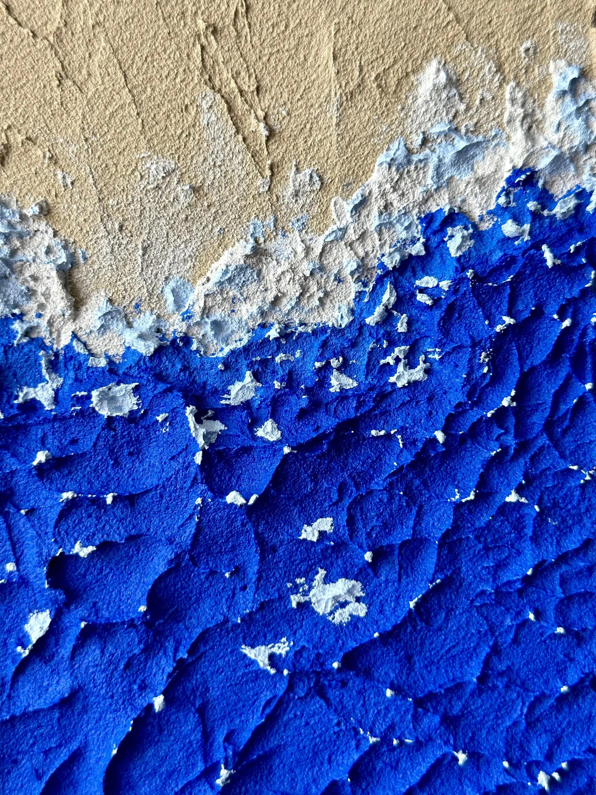 Close-up of textured wall with peeling blue and beige paint.