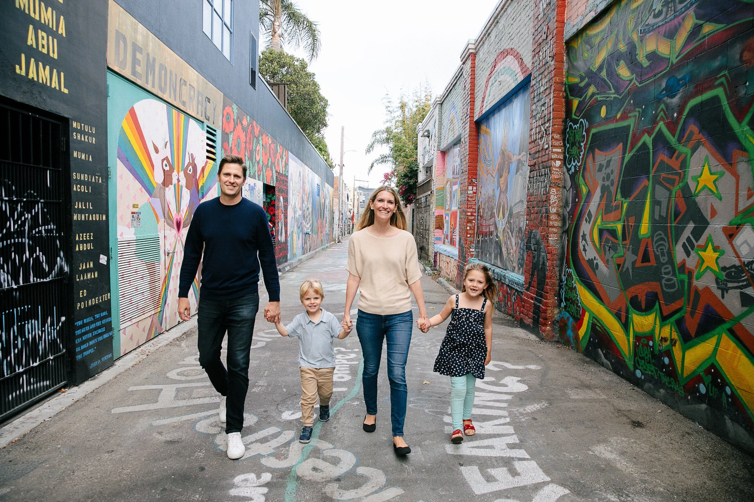 Beautiful family walking through street art in San Francisco, California