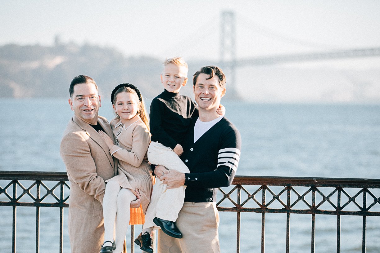 Happy gay couple with their two children in San Francisco, California