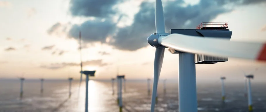 Offshore wind power on the ocean at sunset