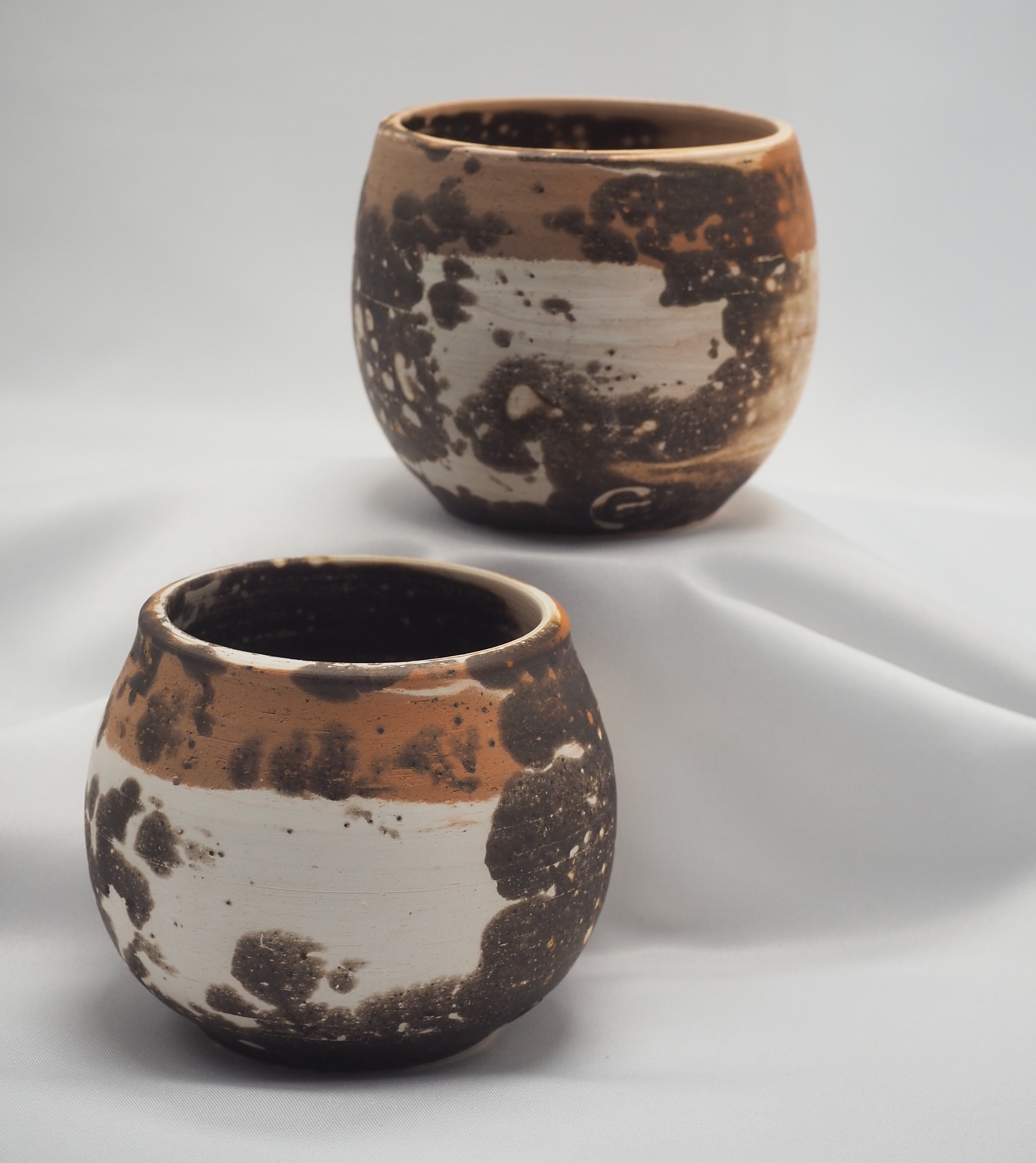 Raku Firing - Obvara technique - Active yeast mixture (sourdough) on terracotta and white earthenware small cups.