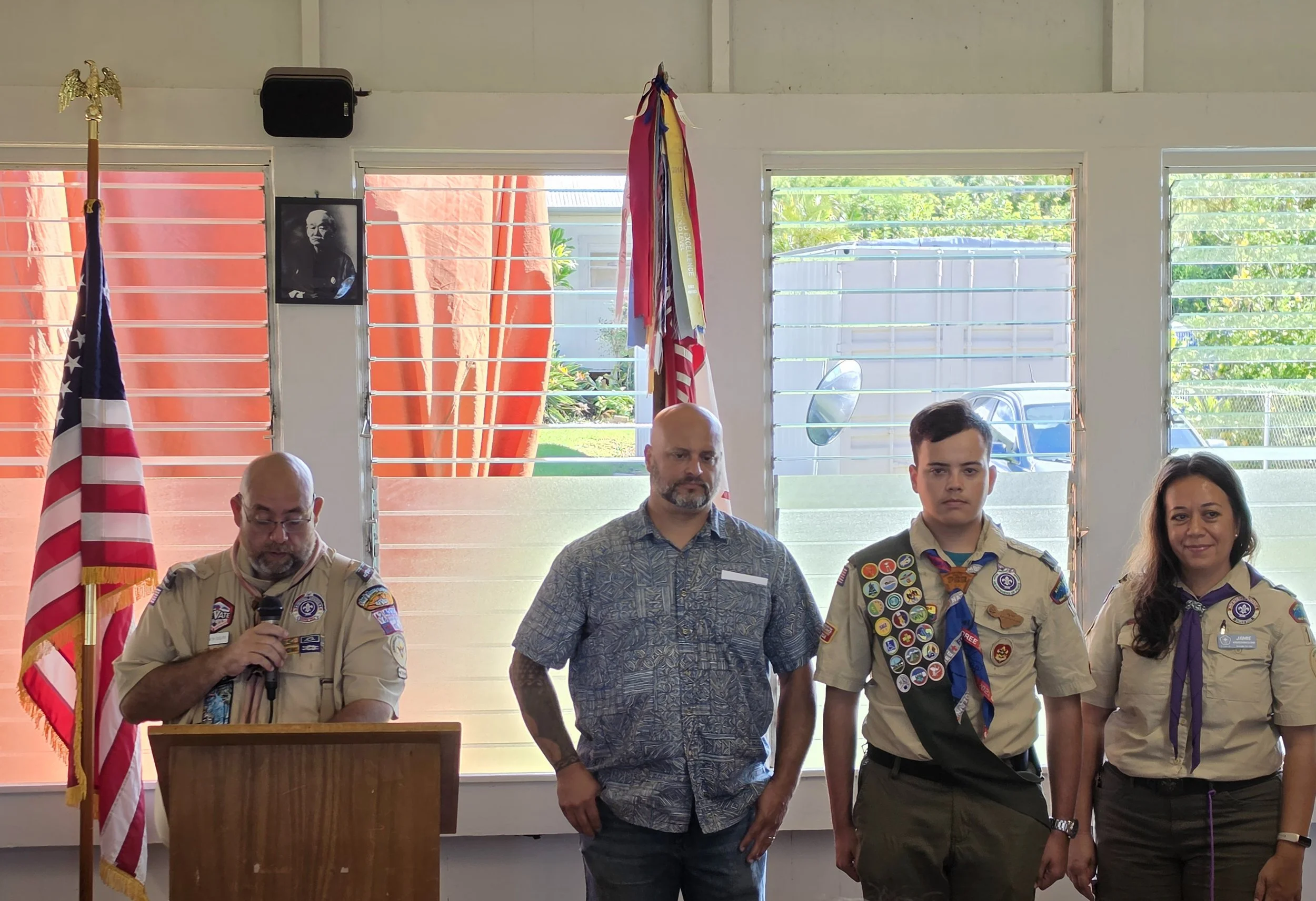 Eagle Parker Kaho'ohanohano with parents and Assistant Scoutmaster Ken Esclito