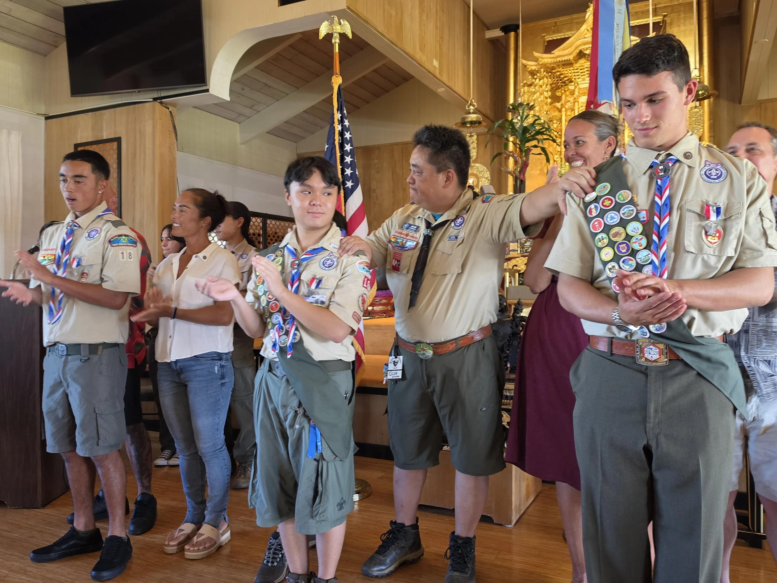 Glen Kitagawa, Asst. Scoutmaster, congratulates new Eagles