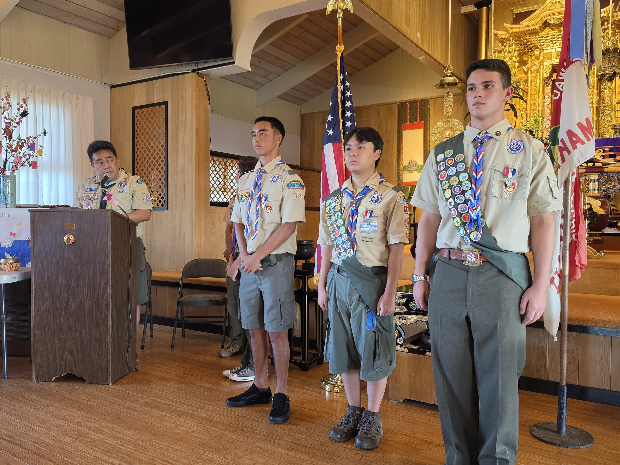 Assistant Scoutmaster Glen Kitagawa congratulating new Eagles