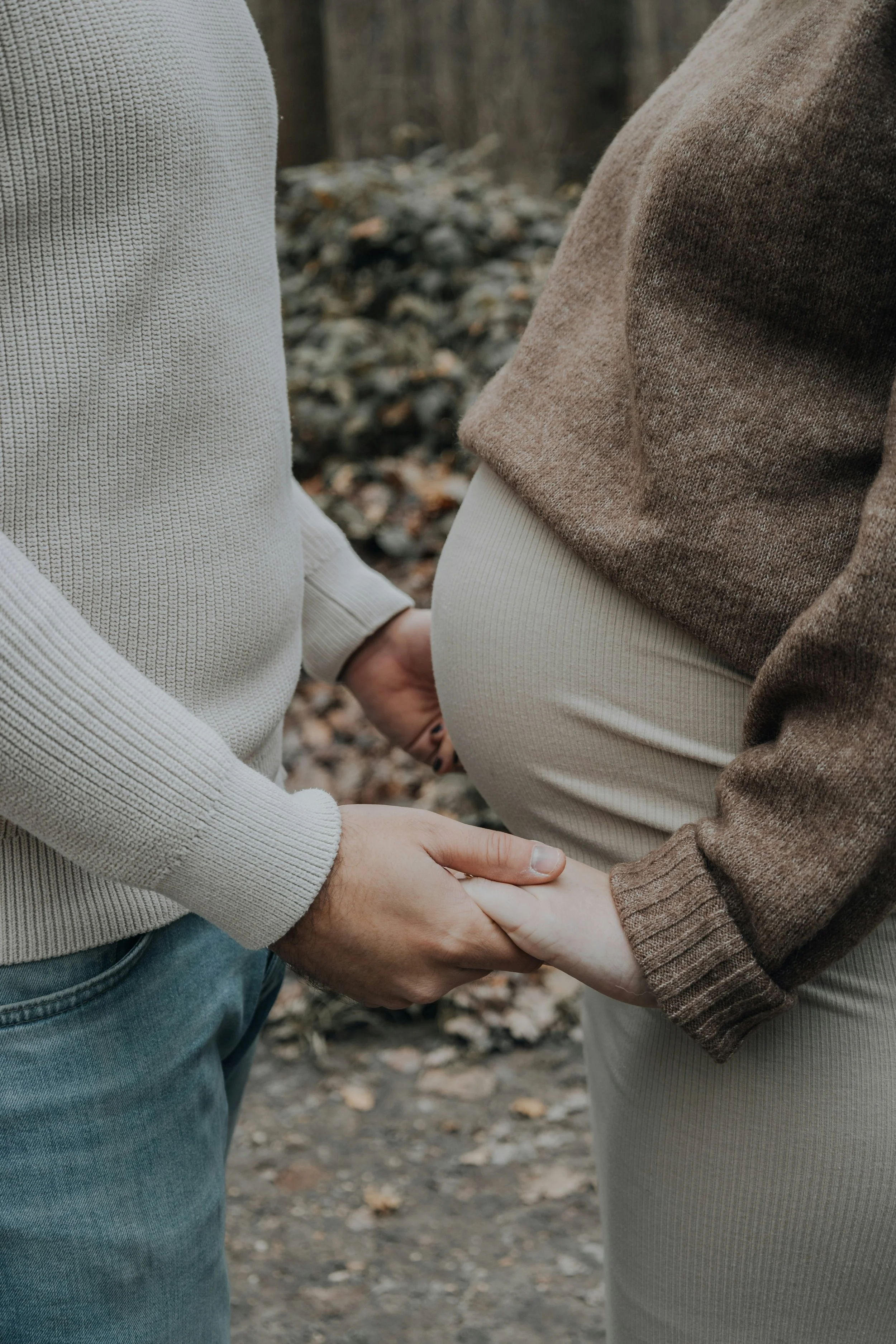 Pregnant couple holding hands