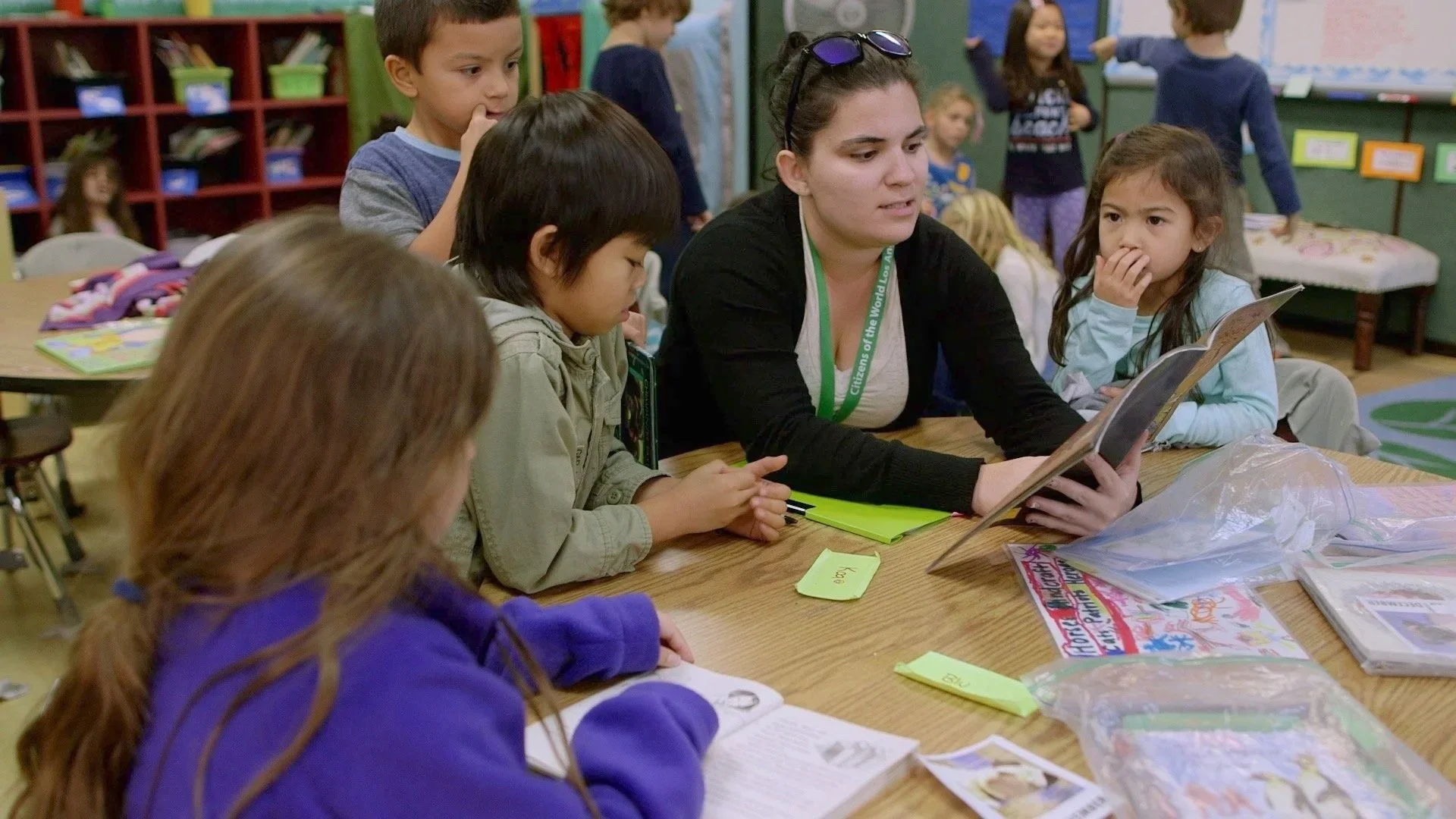 Teacher working with students during a classroom activity at Citizens of the World
