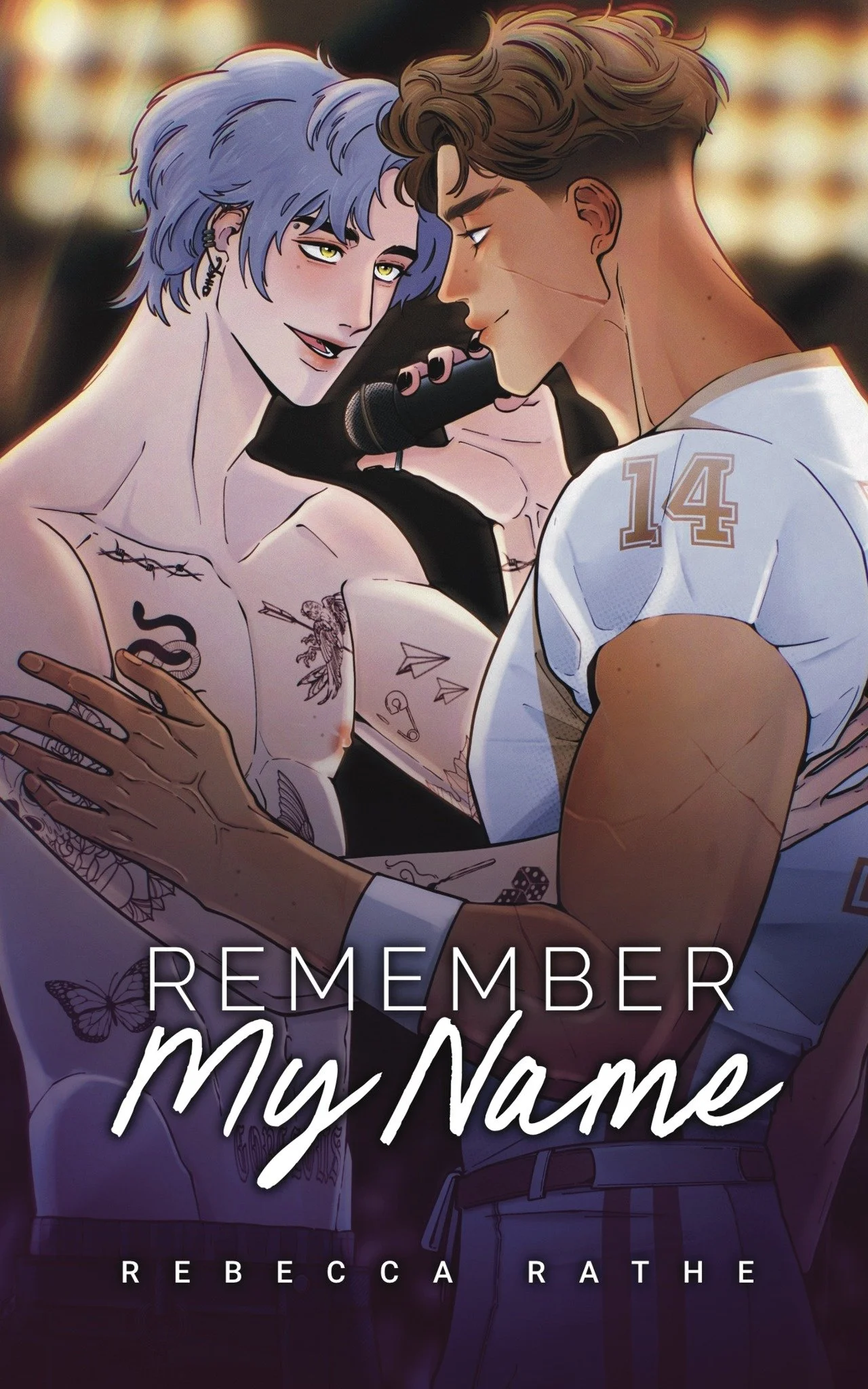Illustration of two young men in an intimate moment, one shirtless with tattoos and the other wearing a white sports jersey with the number 14, holding a microphone close to the other's face. The word "REMEMBER" and the author "REBECCA RATH" are written on the cover.