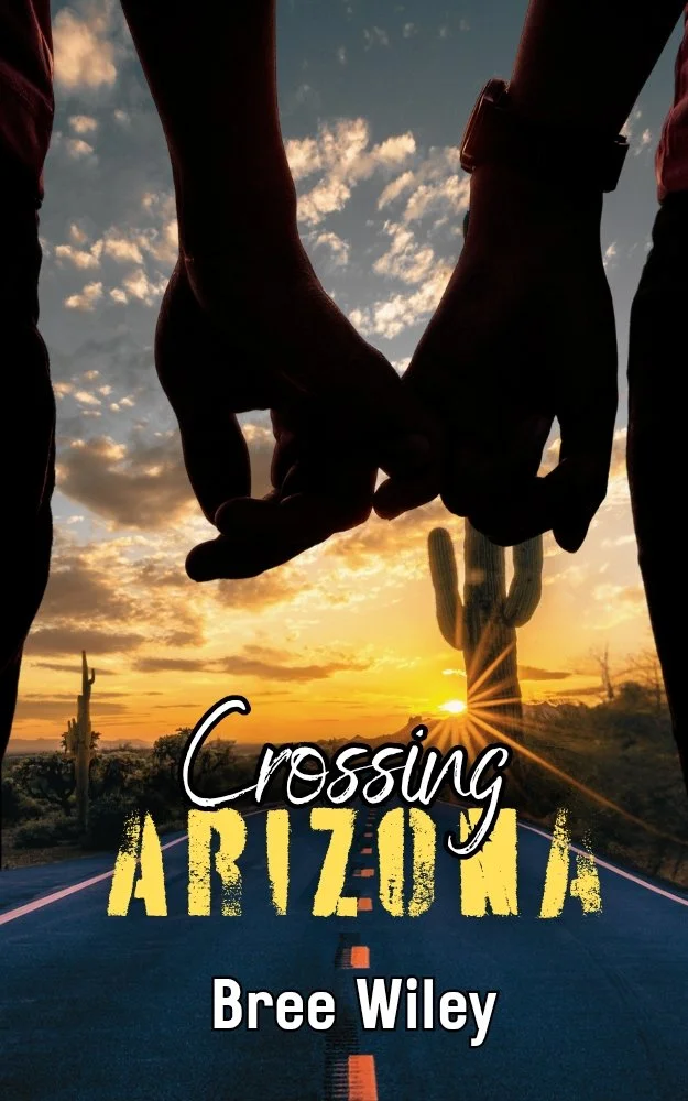Two people holding hands against a sunset sky with desert landscape and cacti, overlaid with the text "Crossing Arizona" and the author name Bree Wiley.