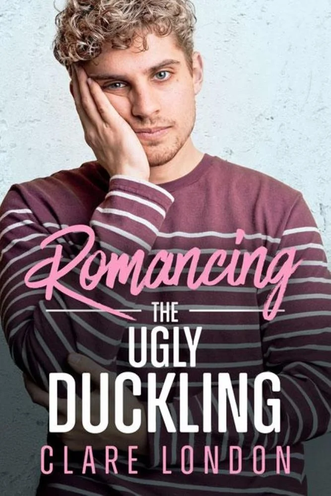 Book cover titled 'Romancing the Ugly Duckling' by Clare London, featuring a young man with curly blonde hair, wearing a burgundy and striped long-sleeve shirt, standing against a light textured background.