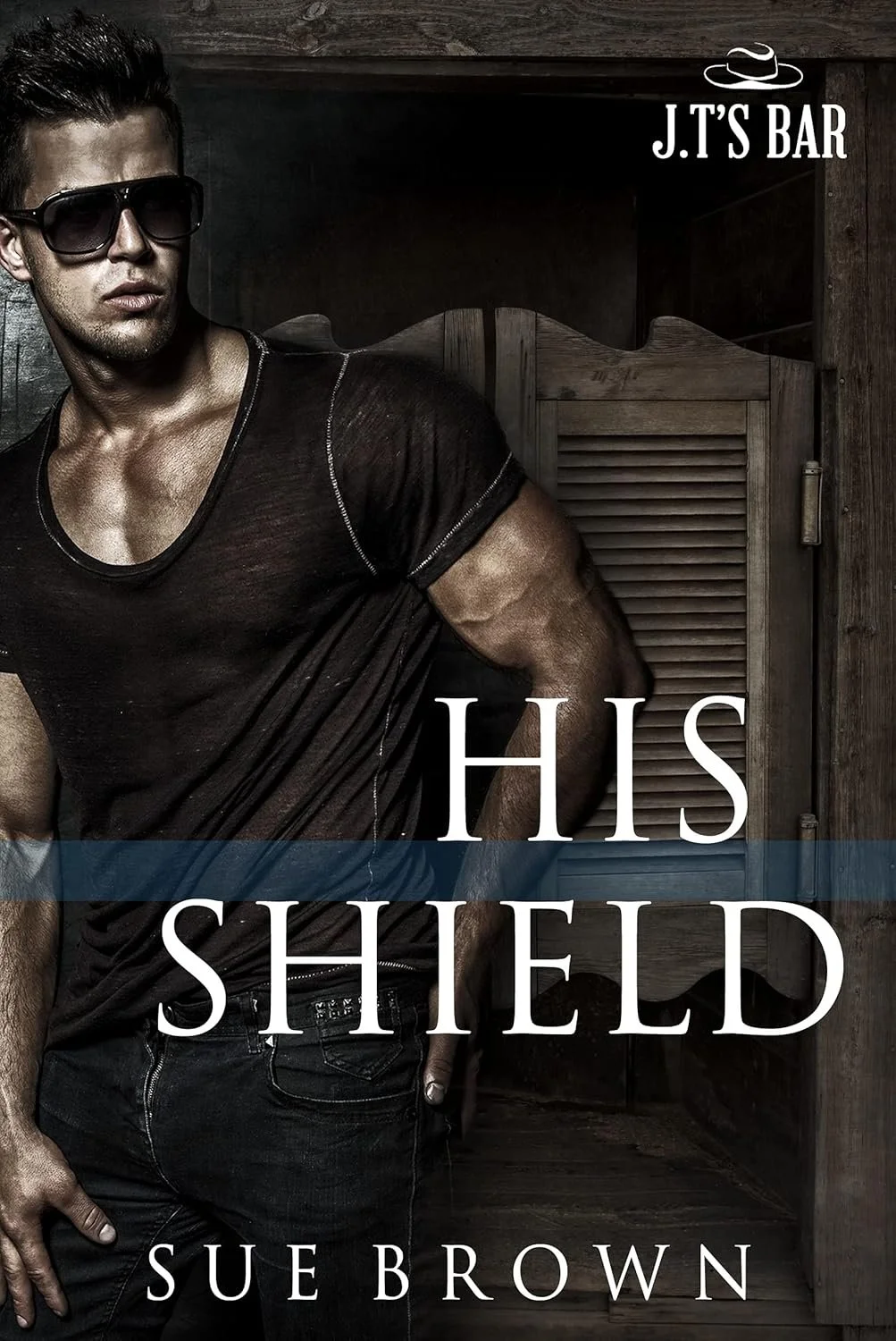 Book cover of "His Shield" by Sue Brown featuring a man wearing sunglasses in a black shirt with a dark background and wooden paneling, with the title and author's name displayed.