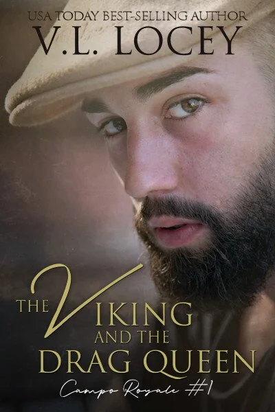 Book cover featuring a close-up photo of a man with a beard wearing a beige hat. The title is "The V"ikings and the Drag Queen", by V.L. Locey.