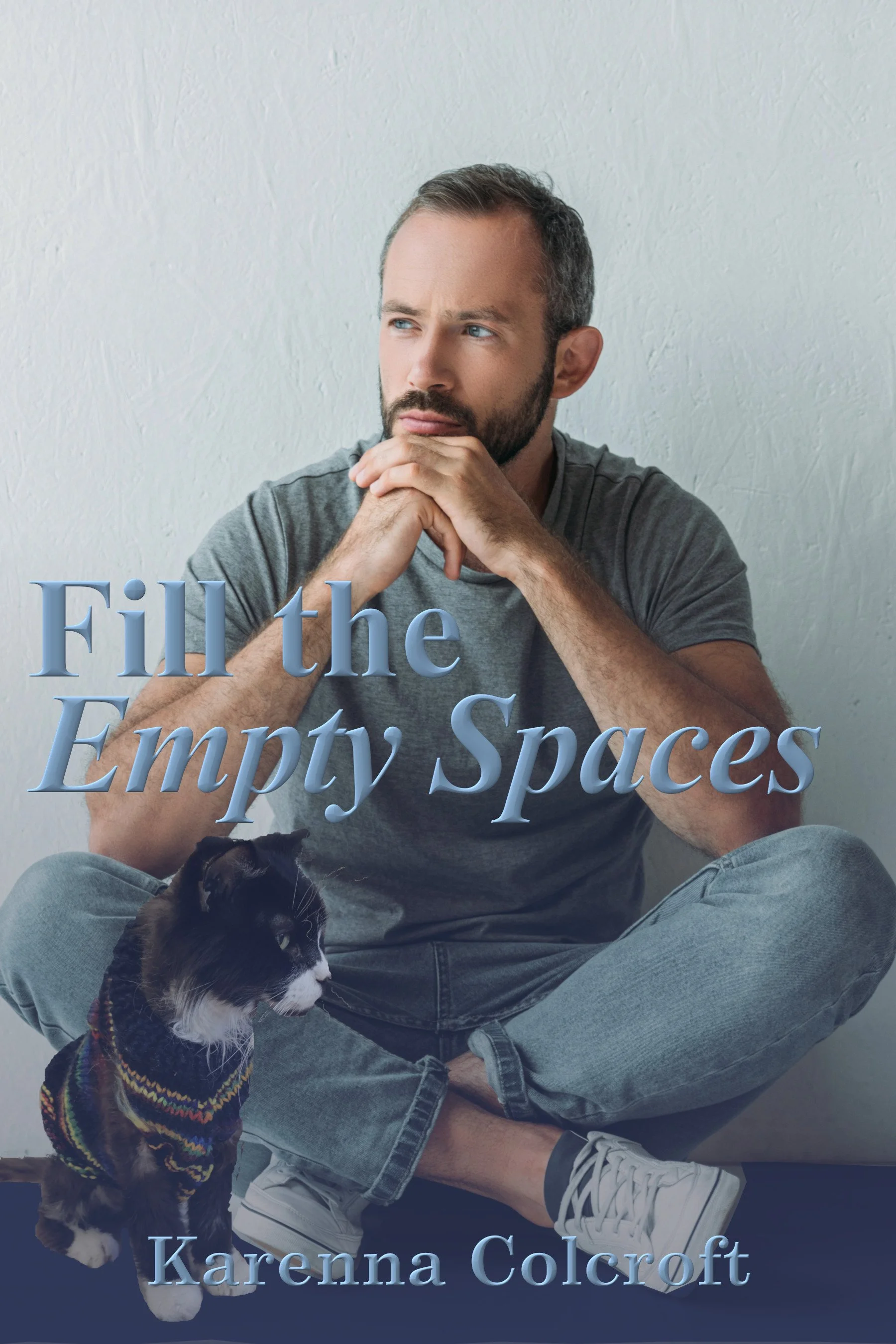 Book cover featuring a man sitting cross-legged with a black and white cat, with the title "Fill the Empty Spaces" and author Karenna Colcoft.