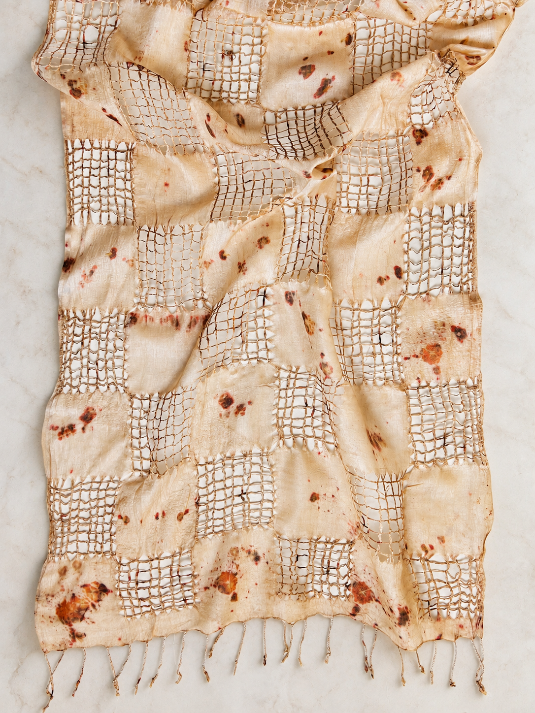 Handwoven tussah silk shawl botanically contact printed with fiery sulfur cosmos flowers and finished with hand-pulled fringe by Flora Obscura.