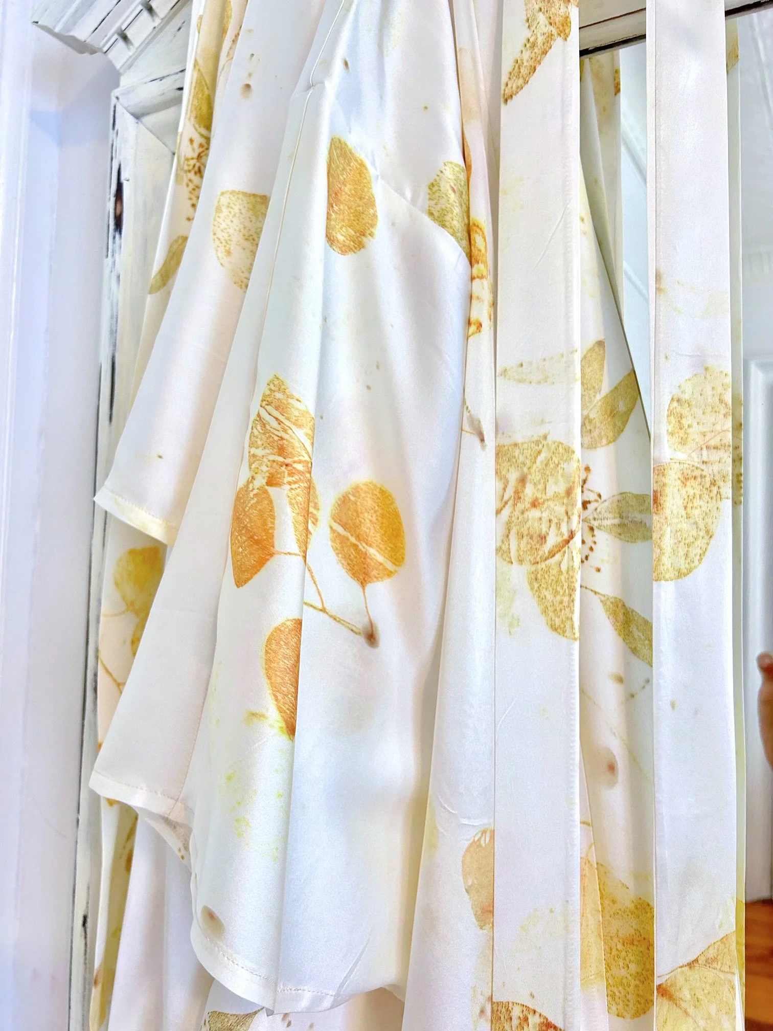 Luxe silk charmeuse robe botanically printed in soft cream and gold. Hand eco dyed, one-of-a-kind, and sustainably crafted for elegant loungewear or bridal wear.