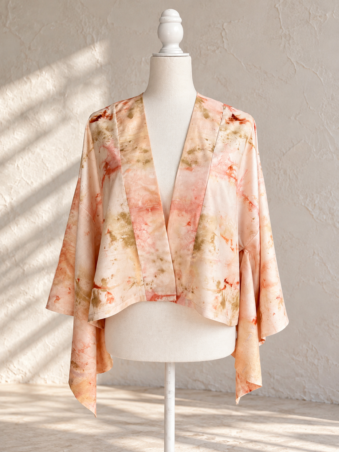 One-of-a-kind cropped silk kimono jacket by Flora Obscura, shibori-dyed with peach annatto and eco-printed with sulfur cosmos and oak gall, featuring a madder-dyed silk charmeuse back panel printed wi