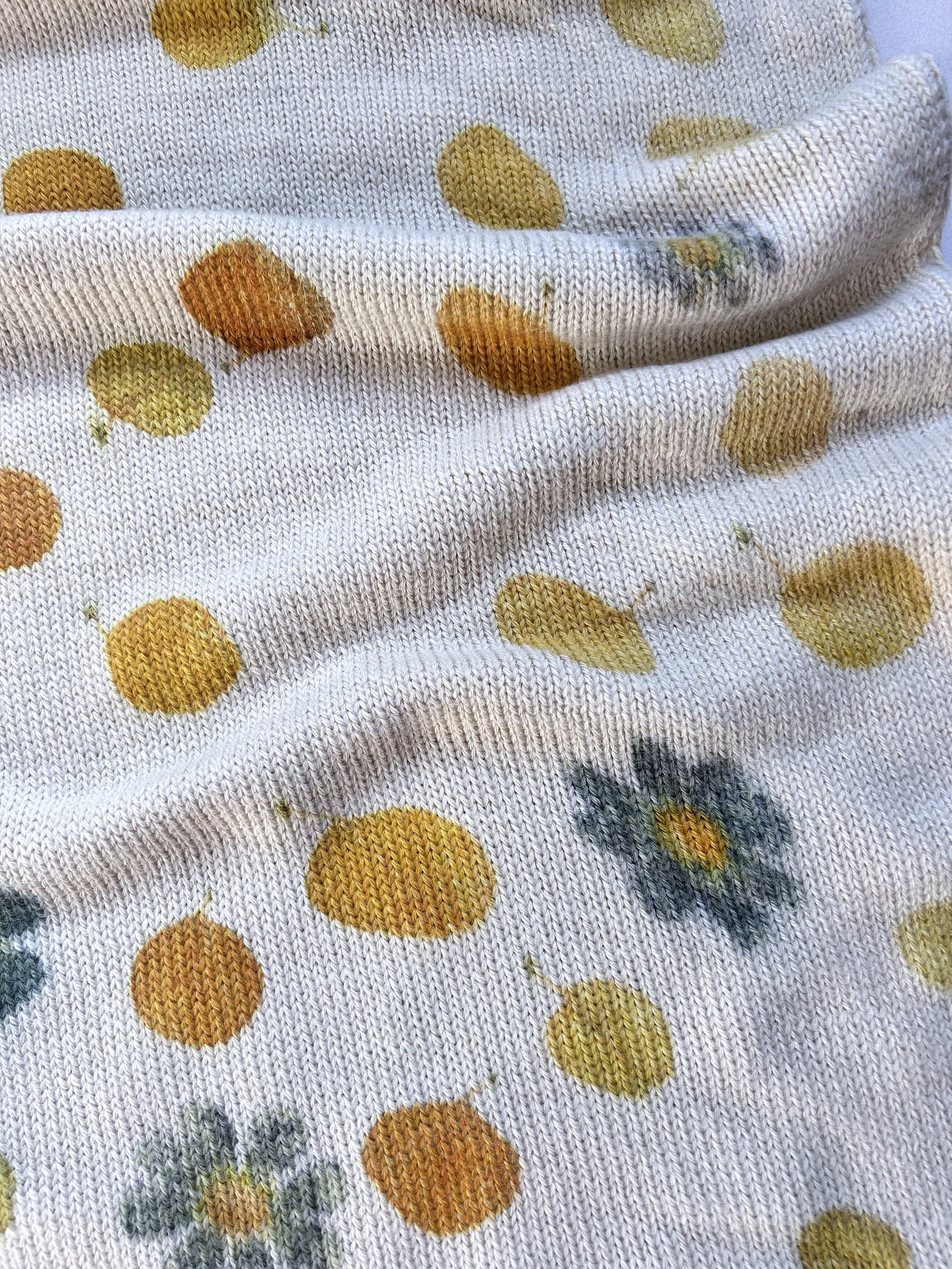Botanically contact-printed ivory Bolivian alpaca wool infinity cowl with golden ochre flowers and muted green botanical impressions by Flora Obscura.