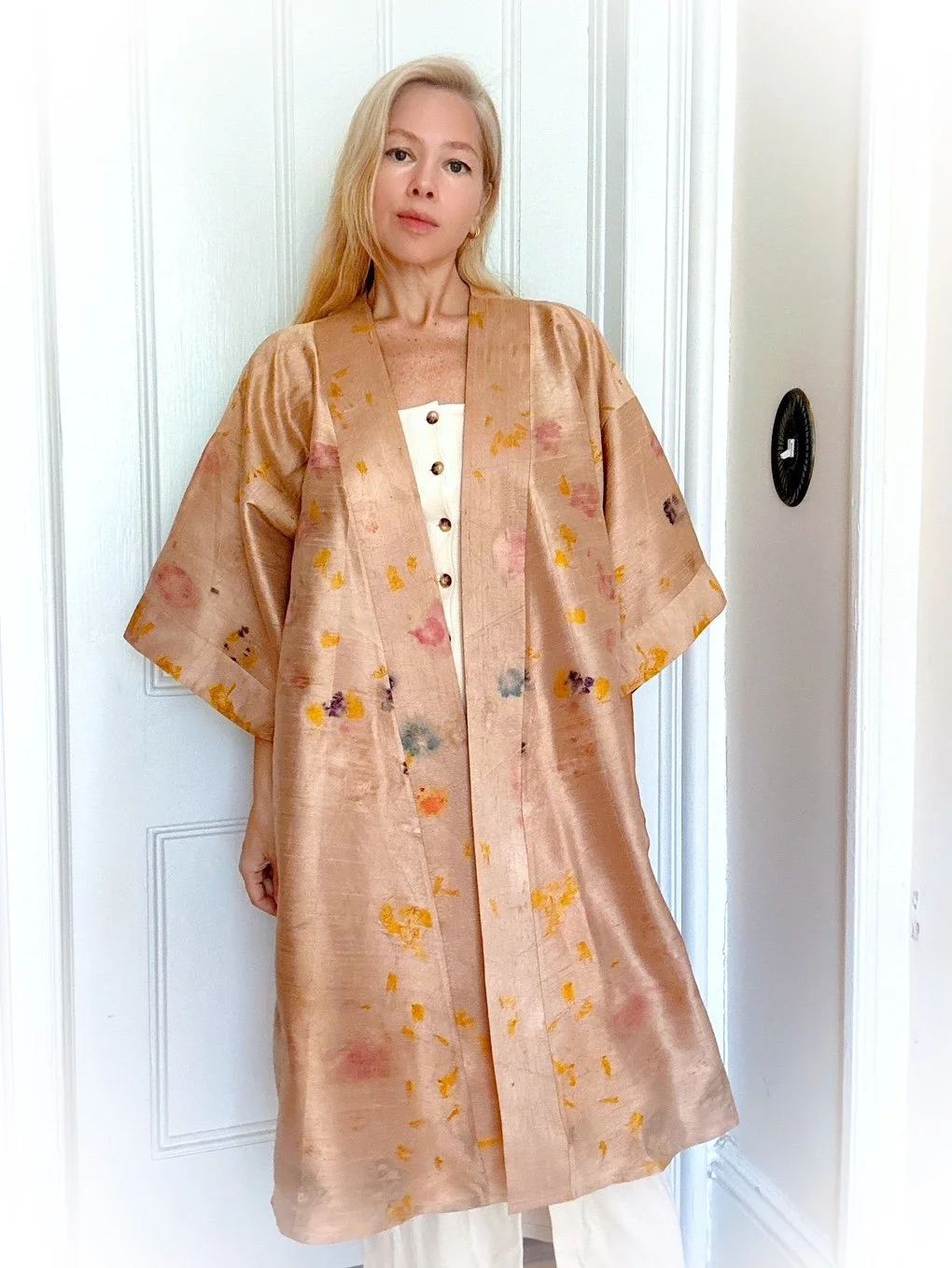 Handmade raw silk robe eco-printed with marigolds, impatiens, begonias, and butterfly pea flowers. One-of-a-kind botanical wearable art with wide sleeves and a flowing silhouette.