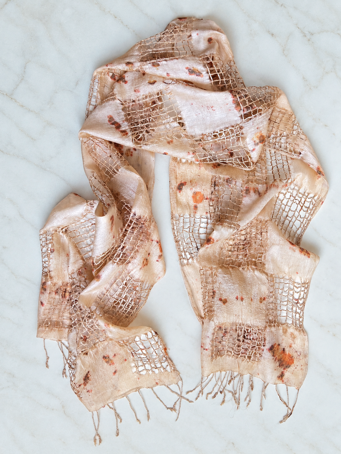 Handwoven tussah silk shawl botanically contact printed with fiery sulfur cosmos flowers and finished with hand-pulled fringe by Flora Obscura.