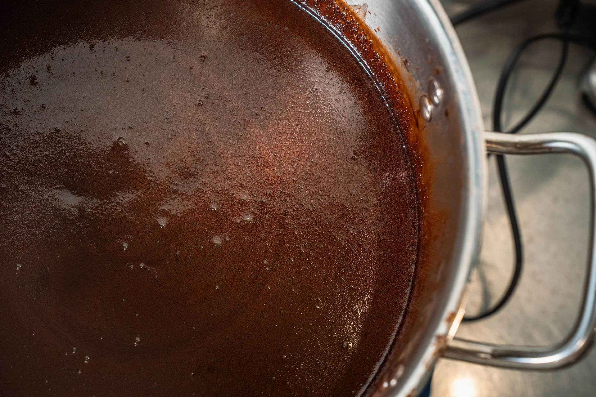 An industrial-sized pot of chocolate sauce.