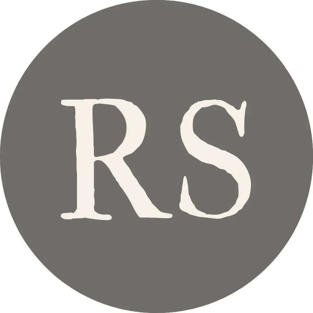 A gray circular background with the white initials 'RS' in the center.