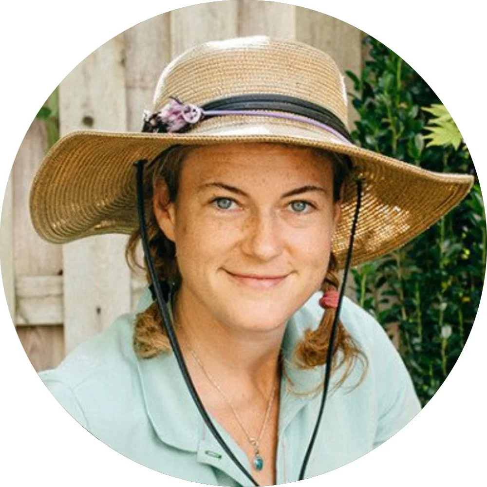 Circular portrait of Grace Wicks smiling with light eyes and hair in pigtails, wearing a wide-brimmed straw sun hat with a chin strap and a light green collared shirt.