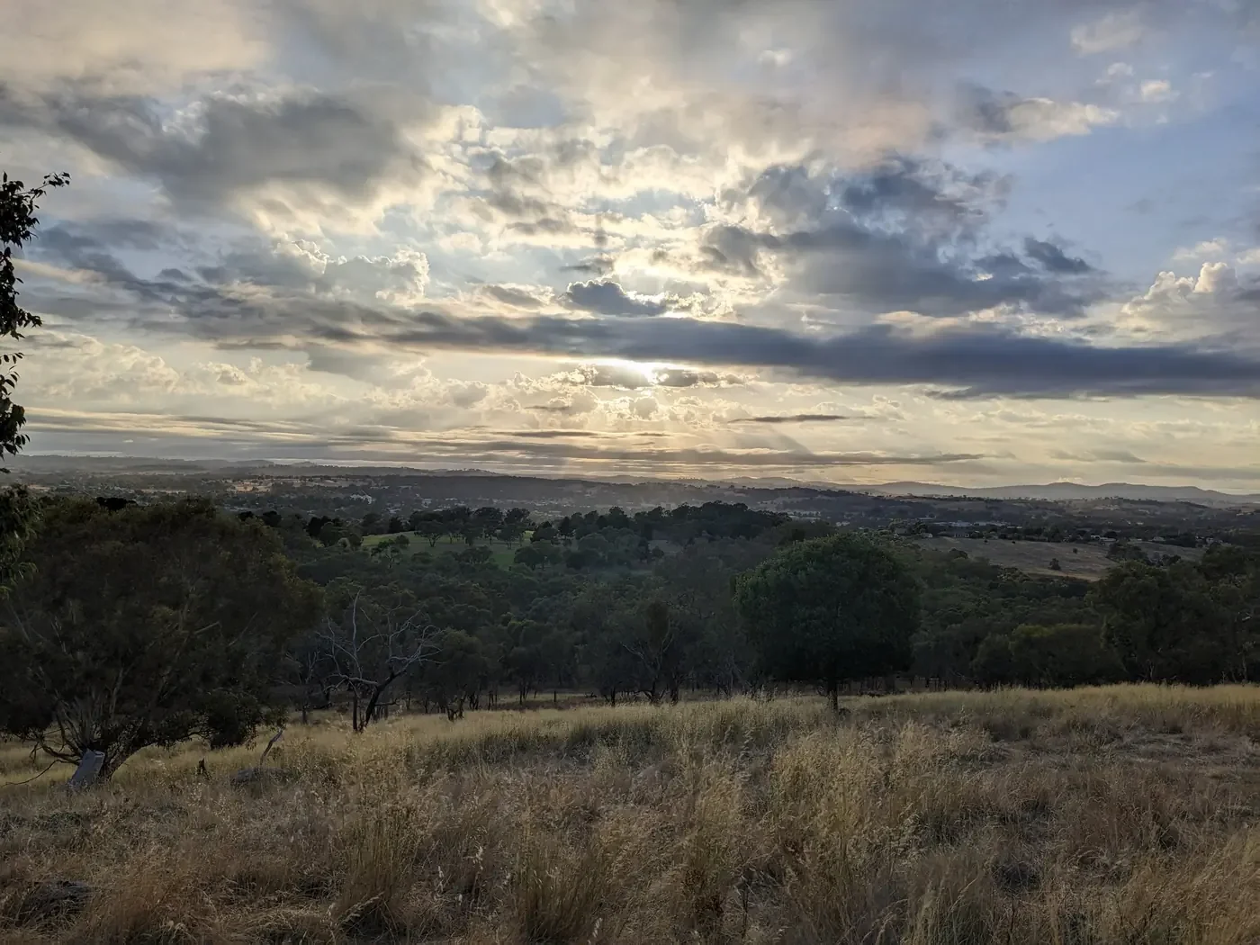 View from the top of a hill looking over hills and houses