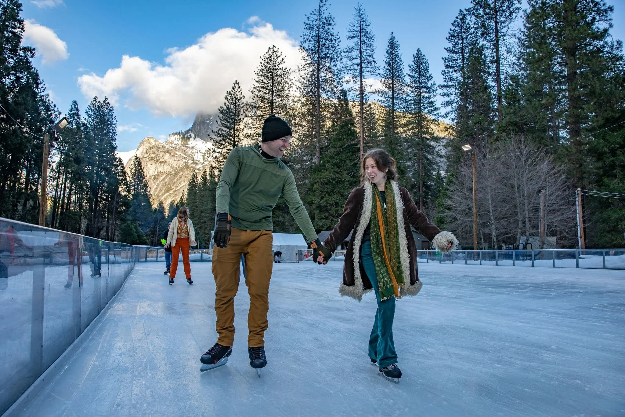 Couple skating outdoors at Curry Village Ice Rink in Yosemite National Park California
