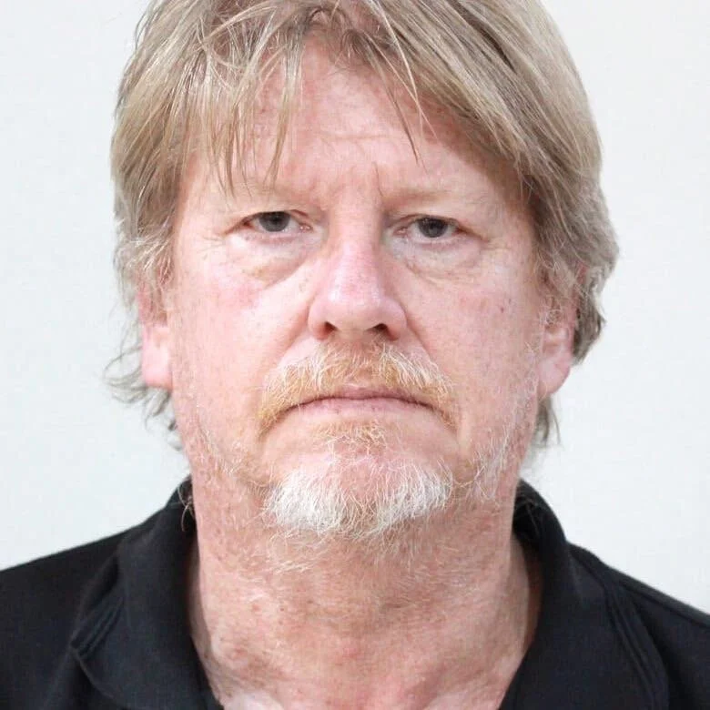 Man with sandy hair and a beard and mustache