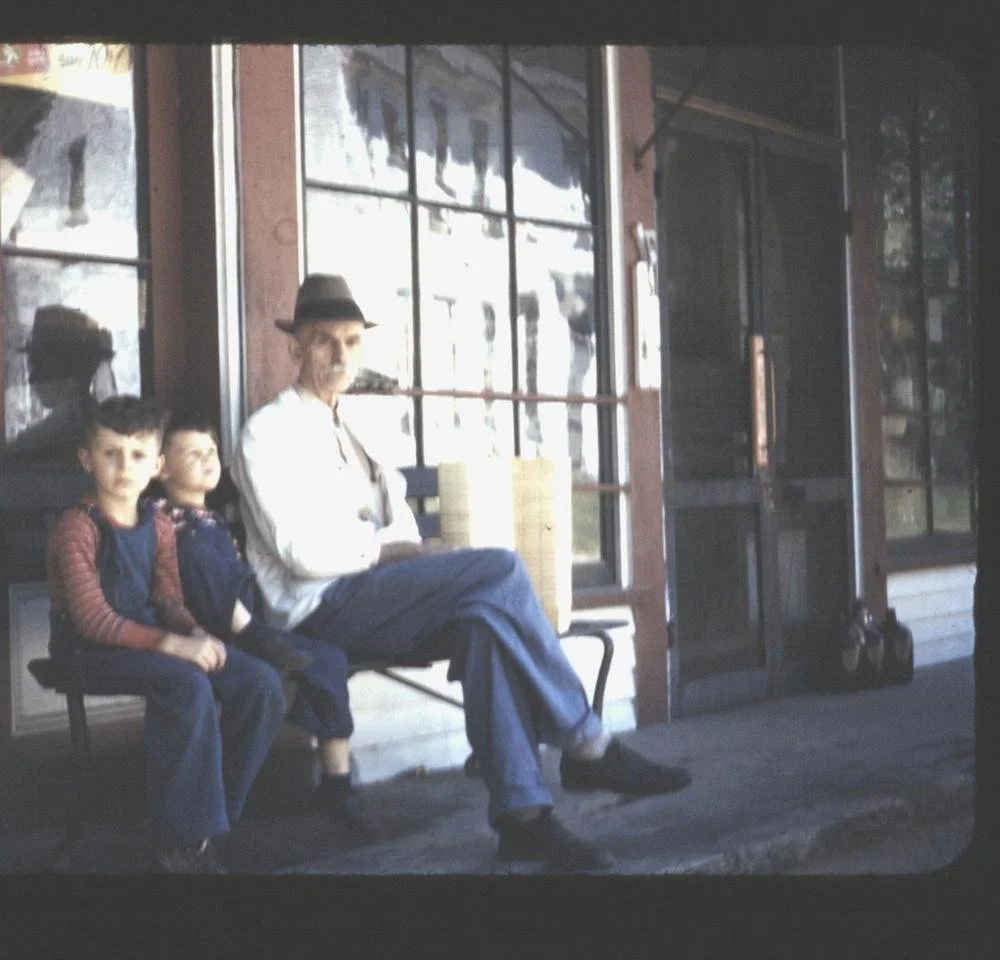 Lon Jewett with the Davis boys outside the Head Tide Store, c. 1943