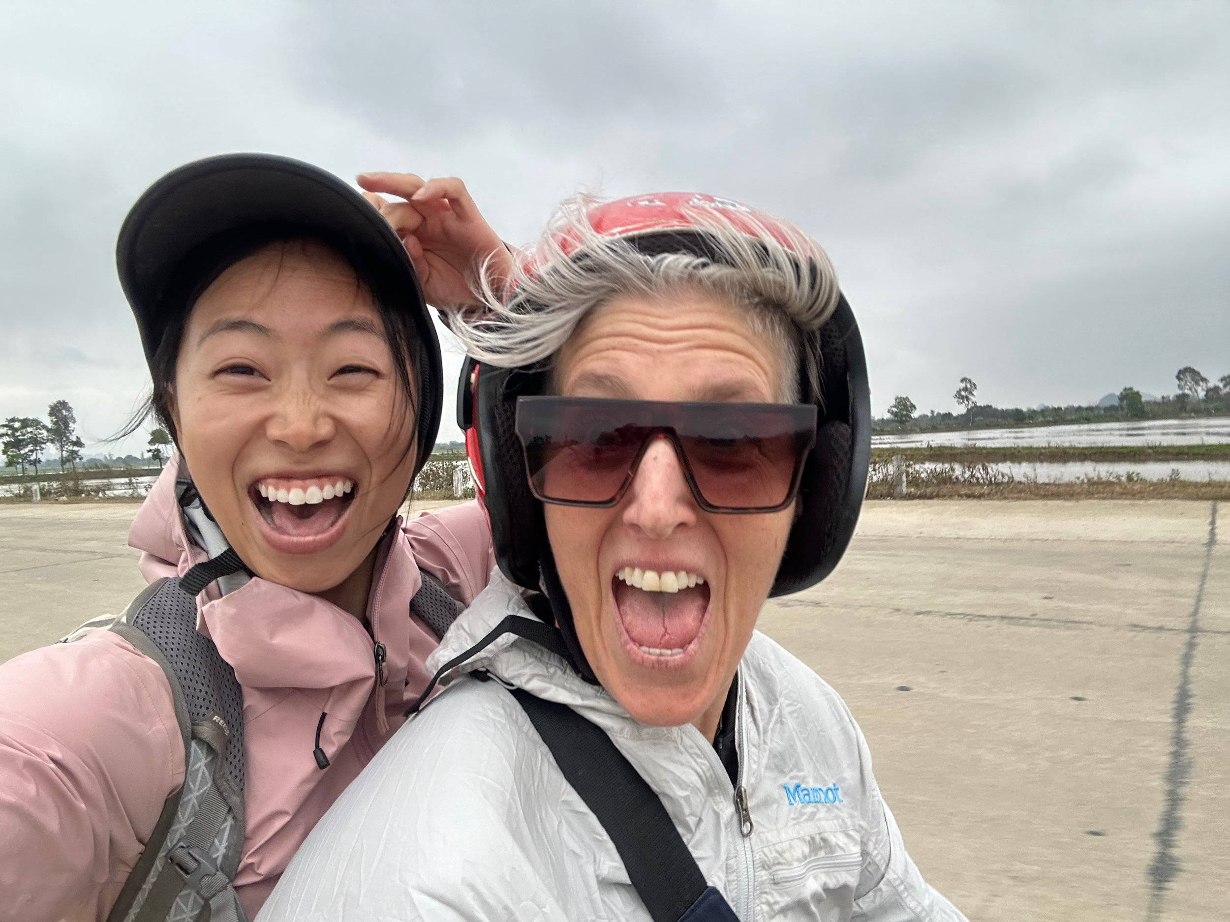 Riding on the back of a motorbike, driven by my friend Catherine, to explore Ninh Binh