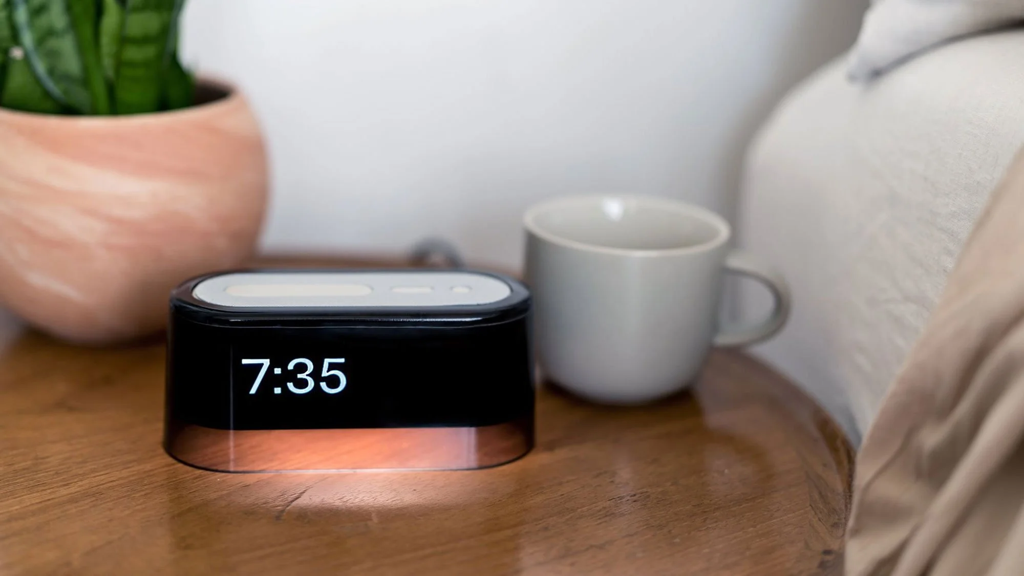 Loftie alarm clock on bedside table