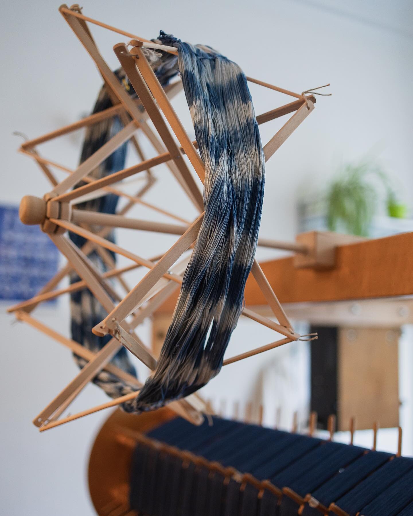 Untangling yarn &bull; Using my old yarn swift, which is basically like a wooden umbrella, to unwind my hand dyed yarns. Normally I am always looking for yarns on cones, but hand dyeing is making me go back to hanks. An extra step but I am liking the